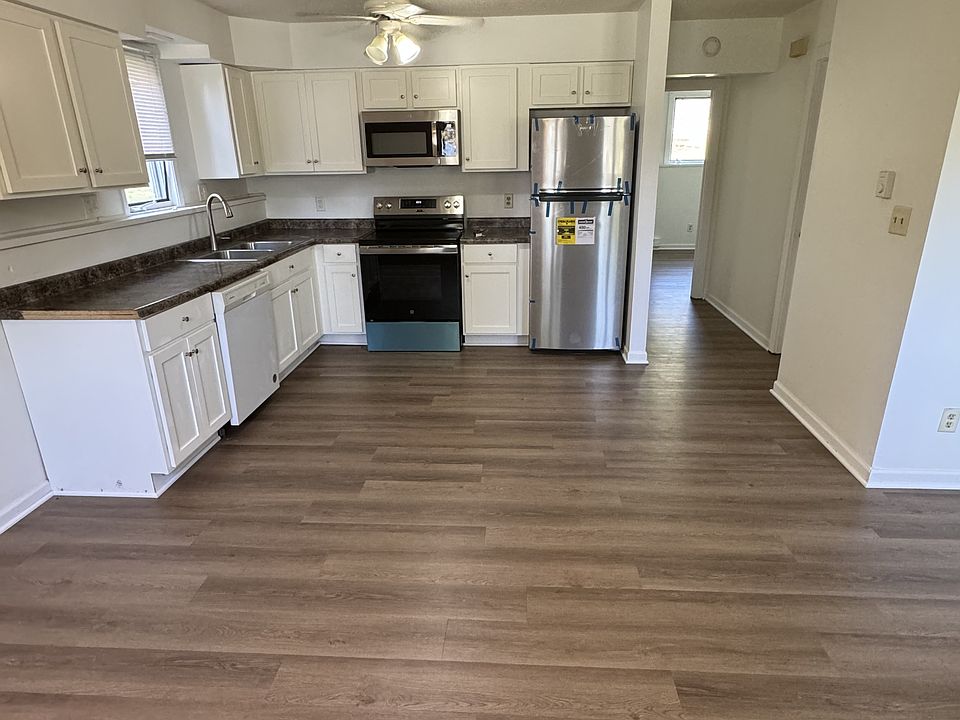 Kitchen with new refrigerator, electric range, microwave