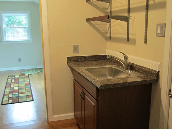 Pull out faucet with storage shelving above