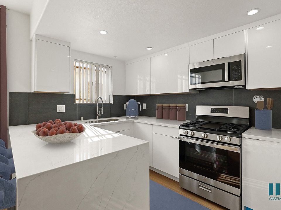 Kitchen with Stainless-Steel Appliances and Countertop Bar