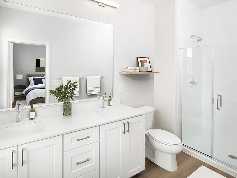 Finish Package I townhome bath with white cabinetry, white quartz countertop, and hard surface flooring