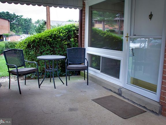 Covered seating area in front of townhome