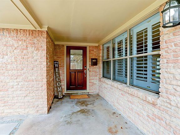 Front porch with pretty beveled glass front door.