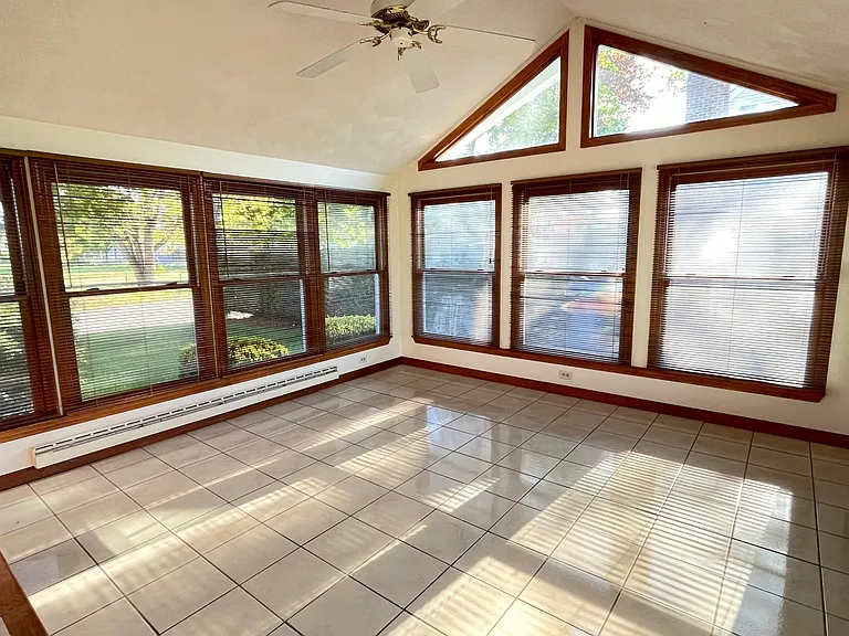 Huge, heated Sun Room with vaulted ceilings and ceramic tile floor.