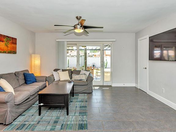 Living room with mounted TV. All entertainment center devices can be wired into the closet so nothing needs to live under the TV.