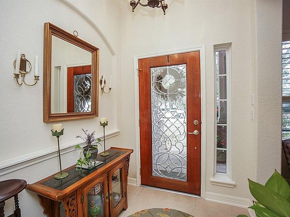 Grand entry with high ceiling and gorgeous leaded glass front door. Formal living room is on the left as you enter (on right in this photo)