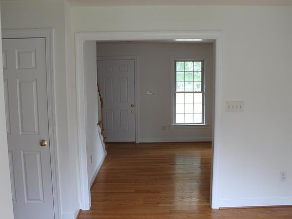 Standing in the dining room looking through the living room at the front door.