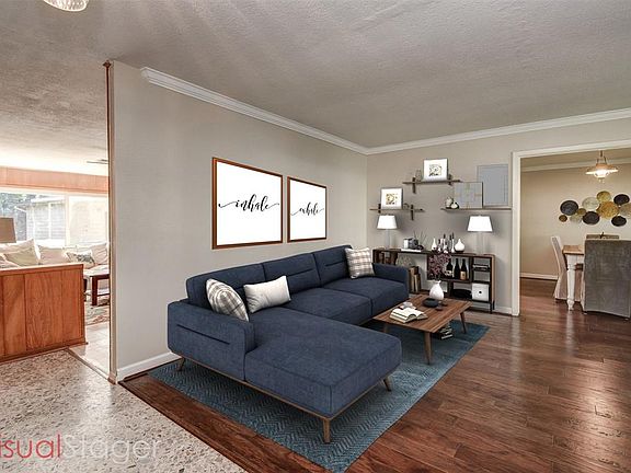Virtually staged living room and formal dining.