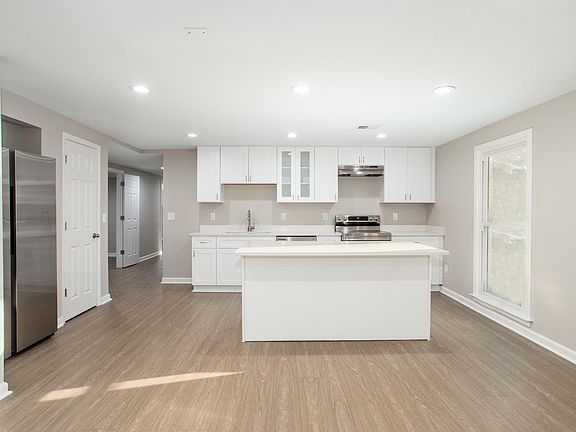 Kitchen / island. Refrigerator and pantry to the left in photo. Window facing yard to the right.