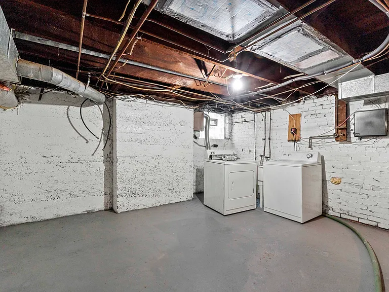 Washer and dryer located in the basement which offers storage and room to have work out equipment, man cave, or hobby space.