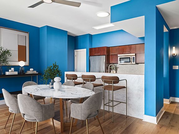 The open kitchen, dining and living room look out to iconic Austin views including the rising skyline and Lady Bird Lake!