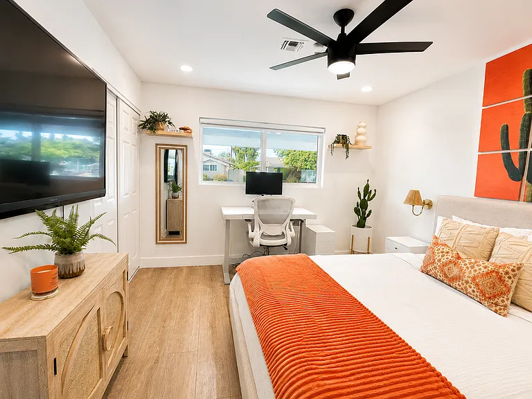 2nd bedroom has queen size, bed, 50 inch TV, and option electric adjustable standing/sitting desk (with monitor)