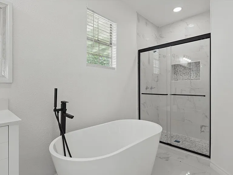 Full bathroom with marble finish floors, a marble finish shower, a soaking tub, vanity, and recessed lighting