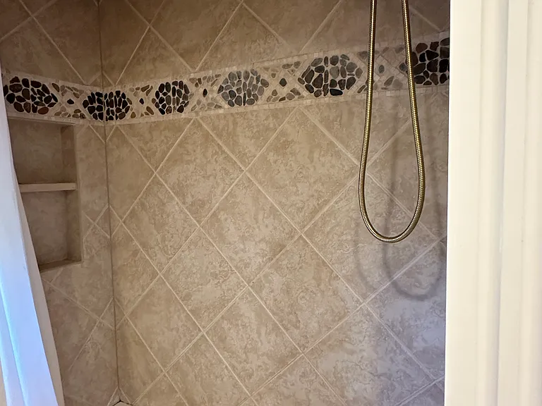 Shower bath in full bath 1 on second floor.