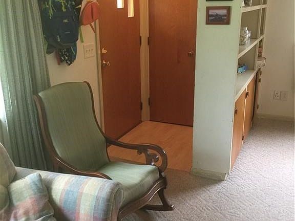 Step inside - vestibule area (with laminate flooring) that leads into living room.