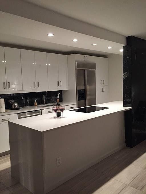 Hi-end kitchen with induction stove and marble accents