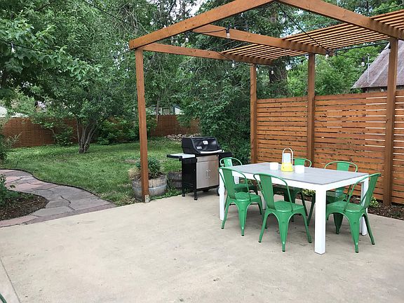 Patio with gas grill, outdoor lights, and dining table for 6.
