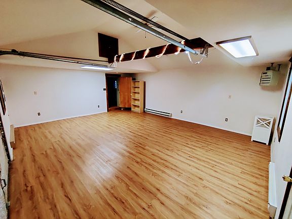 View from inside the front door into the main bedroom and living room space.