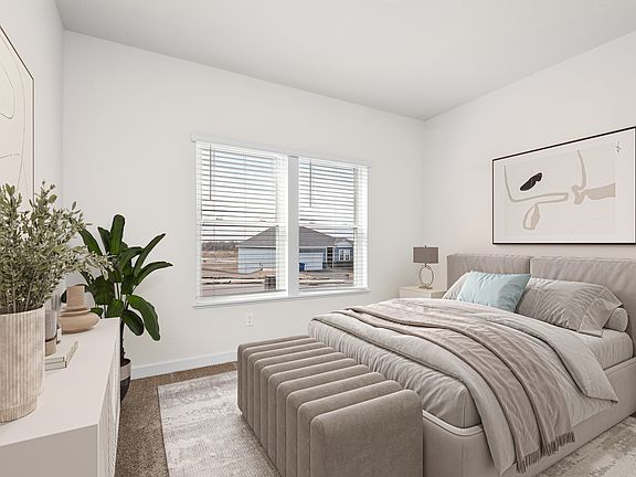 The master bedroom has space for a large bed and two side tables.