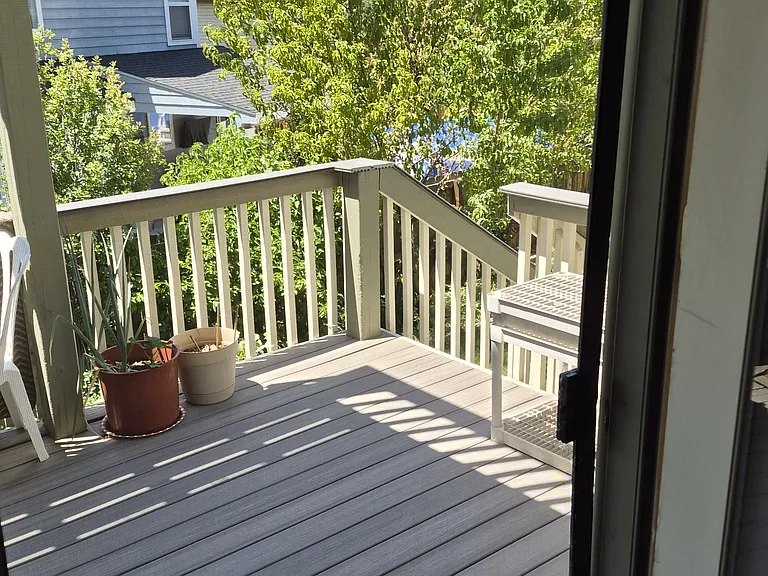 Covered deck with stairs to backyard