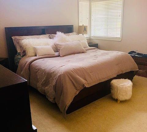 Light master bedroom with vaulted ceiling.