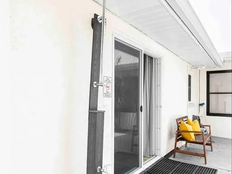 Outdoor shower, sitting area, fully enclosed and private backyard.