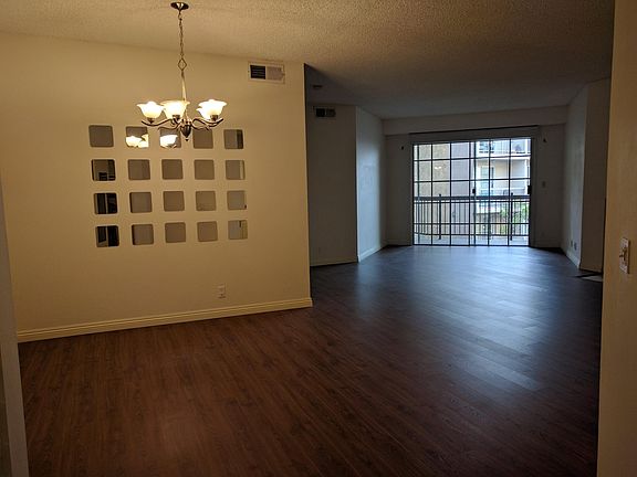 View from doorway towards the dining room and parts of living room.