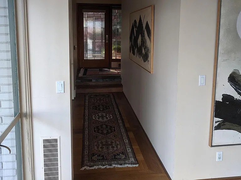 Looking at front door. Sunken living room (hall) as seen from Dining Room. Rug & paintings have been removed