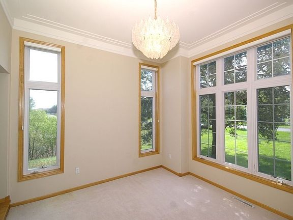 Beautiful formal dining room with racetrack ceilings & 8' tall windows!