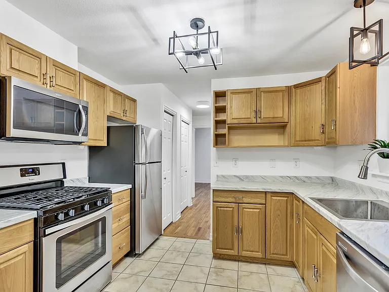 Large kitchen, new counters, sink & faucet. Stainless steel appliances. Gas stove/oven.