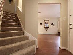 Gleaming wood flooring gives these rooms a rich flavor.