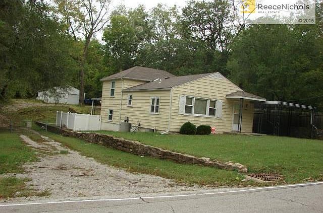 Front view of large lot,surrounding trees