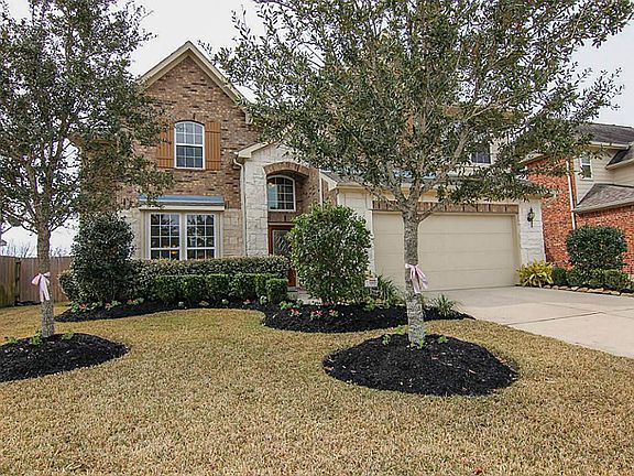 Beautiful landscaping and a covered front entry add to the curb appeal of this pretty home.