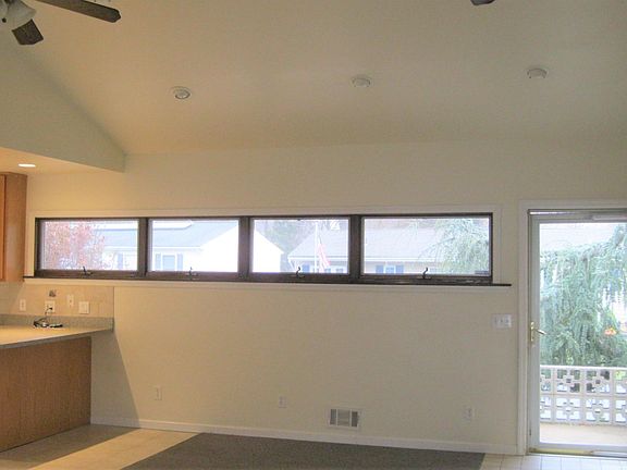 view of front door, kitchen off to the left. high ceilings.