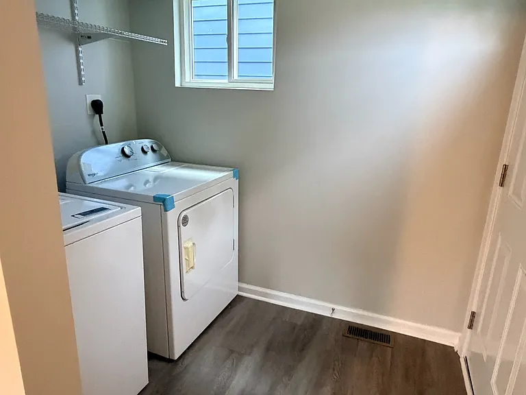 Laundry room with washer and dryer. The back door provides direct access to the backyard.
