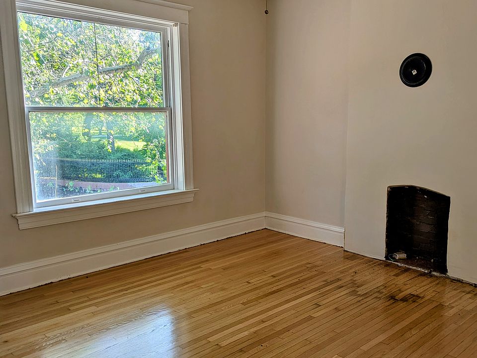 Front living/dining room. Fireplace is not in use and renter may add a mantle or speak with landlord about cosmetic changes to the fireplace.