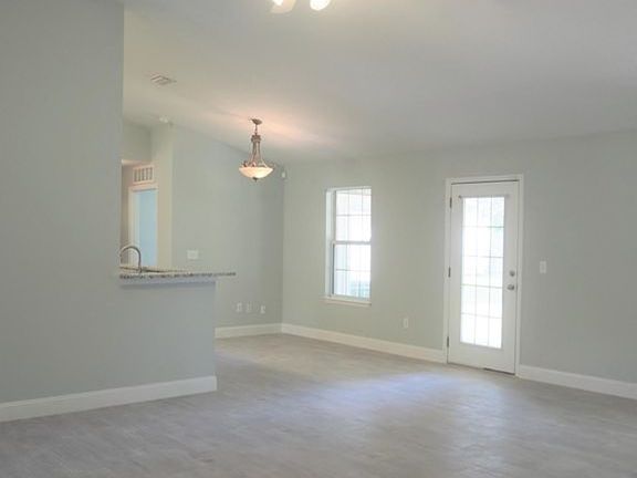 Family room with cathedral ceilings looking toward kitchen and breakfast area