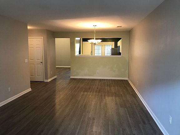 Front entry view into living/ dining area & kitchen . Powder room, garage access & coat closet located on the left.