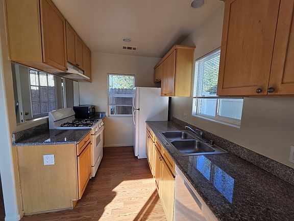 Kitchen area with refrigerator, microwave and dishwasher