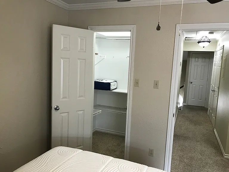 Secondary Bedroom #2, furnished with full size bed, tall dresser, desk, chair, & nightstand. Walk in closet. Private space for occupant of secondary bedroom #2.