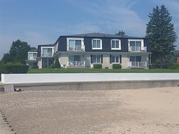 a view of the condo from the sandy beach