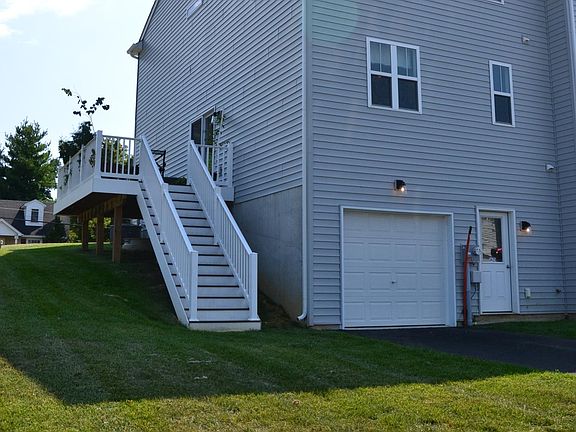 One car garage with one parking space in driveway. Ground level entrance door into basement mud area.