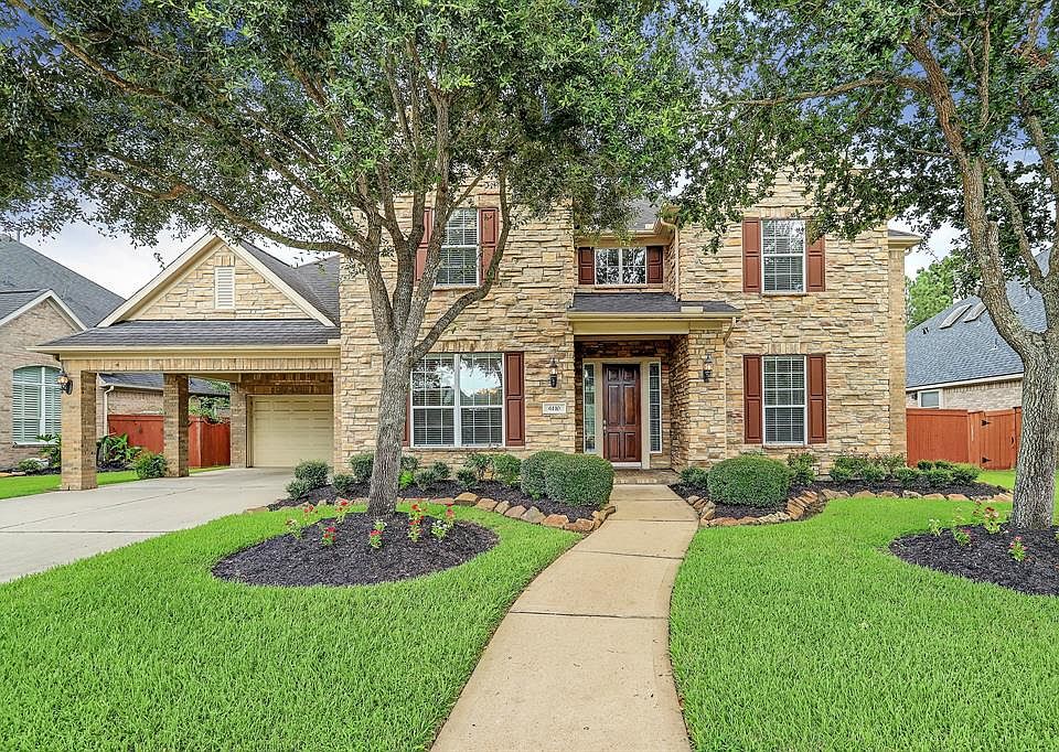 Stately stone elevation with 2 car porte-cochere