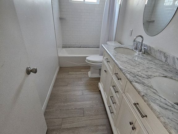 Guest Bath shared by both Non-Master bath. All new . New window fan lighting etc and tile