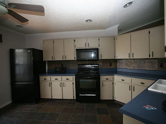 Kitchen with Slate floors and backsplash