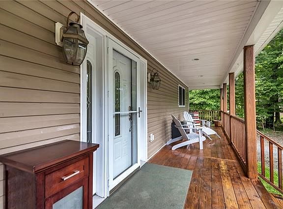 Enjoy the nature around you from your full length rocking chair front porch