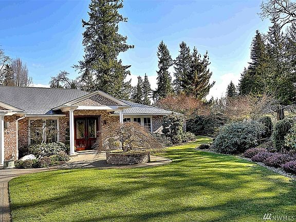 Custom brick rambler on .51 acre professionally landscaped lot. 