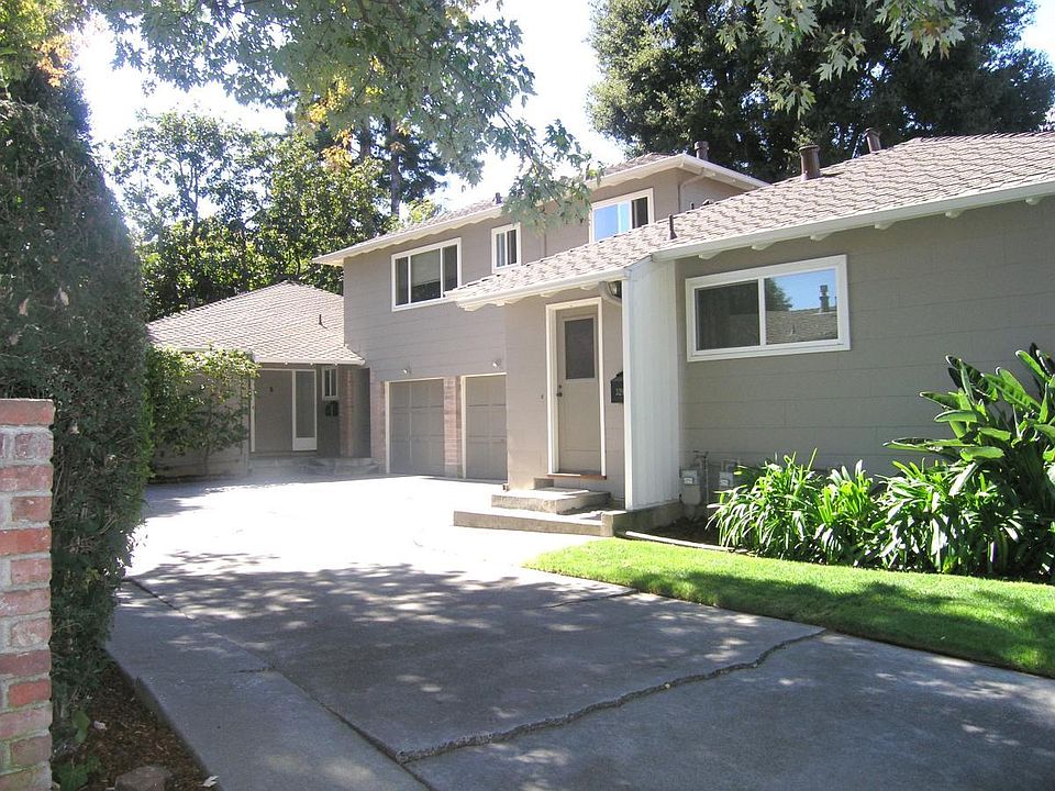 View of the triplex from the driveway. 329 Waverley is closest to the sidewalk, 327-A is above the 3 garages, and 327 is at the rear of the property. No apartment shares a wall in common with the others.
