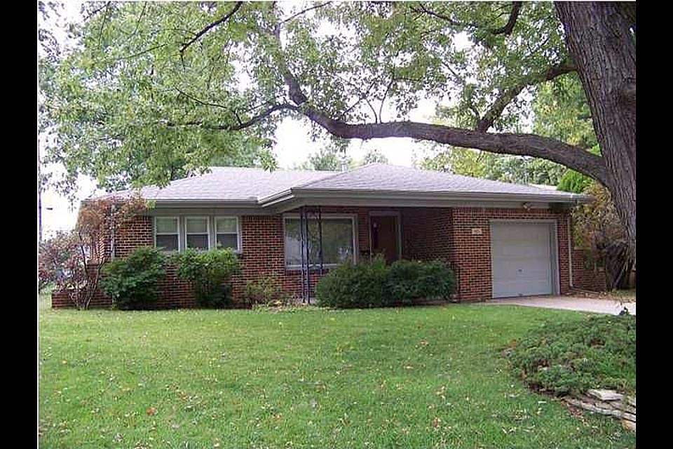 Large trees and lot with sprinkler system.