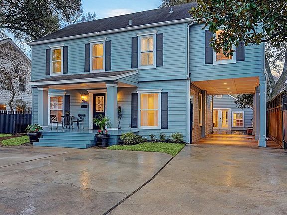 Gated 2 car attached carport nicely lit.