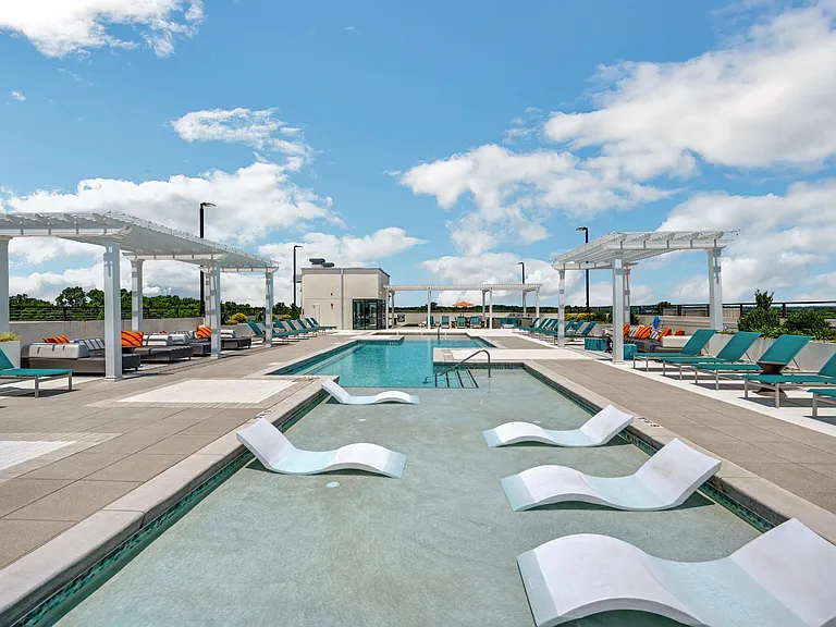 lounge chairs that sit inside the shallow part of the pool